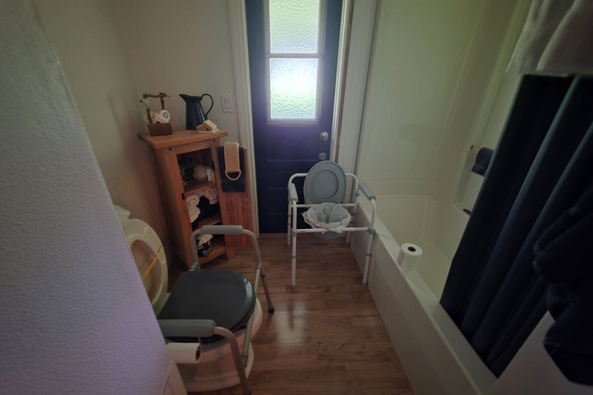 The same view before the work: dim and cluttered, with a bath and the original fittings