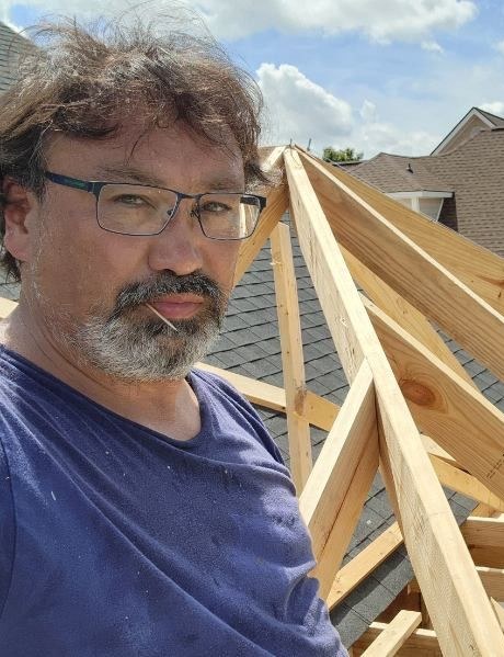Joe Messier on a roof, framing trusses