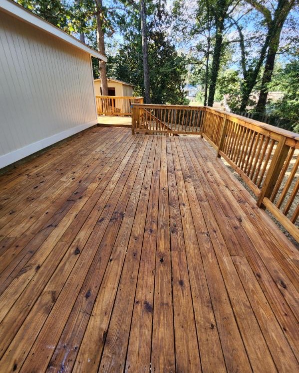 Restored wood deck with fresh stain, running to a matching handrail