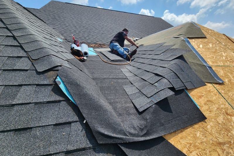 Laying shingles across a roof deck