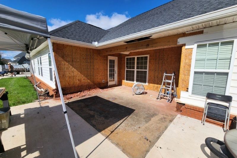 Brick house exterior with a newly poured patio